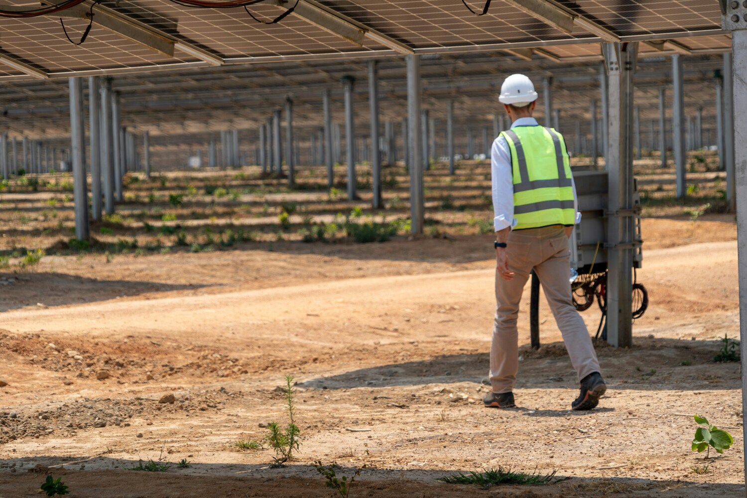 Engineer inspecting solar energy infrastructure supporting the energy transition